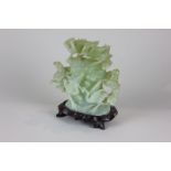 A Chinese green jade coloured glass carved ornamental teapot decorated with storks amongst foliage