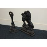 A cast iron doorstop modelled as a lion rampant, 37cm high and another as an inverted flower,