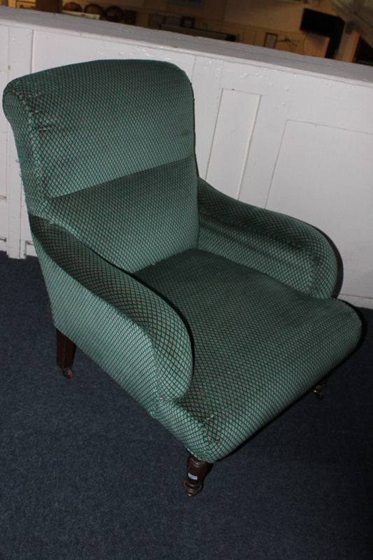 A Victorian upholstered armchair, in green trellis pattern, on turned legs and castors