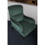 A Victorian upholstered armchair, in green trellis pattern, on turned legs and castors