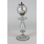 An early 19th century glass lace makers lamp with baluster stem on circular base 26cm