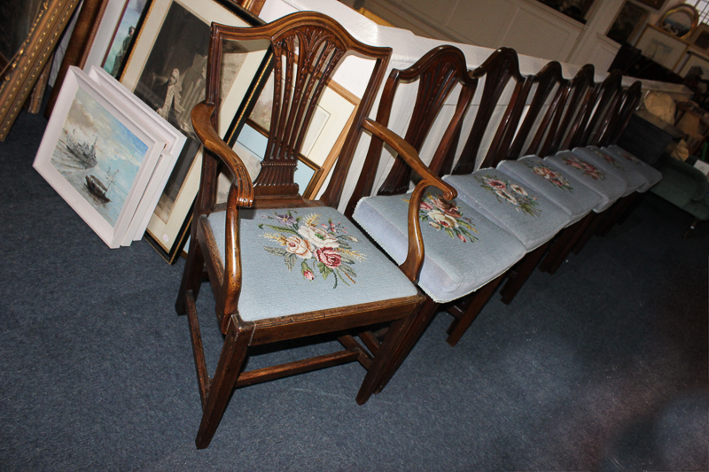A set of six mahogany dining chairs, with arched backs and pierced wheatsheaf backs, blue tapestry