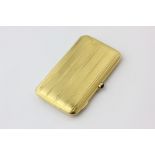 A French 18ct gold cigarette case rectangular engine turned with cabochon sapphire thumbpiece