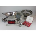 A Victorian silver plated cake basket, a silver plated ladle, toast rack and basket, two cased