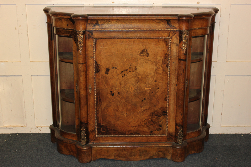 A Victorian walnut credenza with inlaid scroll decoration, ormolu mounted with central panel door