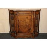 A Victorian walnut credenza with inlaid scroll decoration, ormolu mounted with central panel door