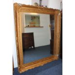 A giltwood and gesso large rectangular wall mirror, with scroll decorated border (a/f), overall size
