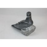 An Inuit hardstone carving of a bird, inscribed Johnny 1616, with paper label to base stating "