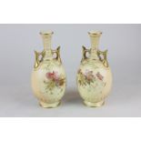 A pair of Royal Worcester porcelain blush bottleneck vases with hand painted floral decoration and