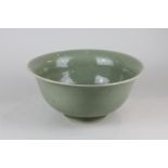A Chinese celadon bowl with flared rim, on circular foot, blue seal mark to base (a/f), 26cm