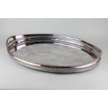 A large oval galleried silver plated tea tray with gadroon border 62cm long