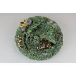 A 19th century Caldas Palissy style plate decorated in relief with lizards, butterflies, grubs and a