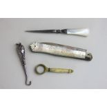 A silver beaded fruit knife with mother of pearl handle, a silver handled button hook, a mother of