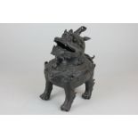 A Chinese bronze censer, in the form of a Buddhist lion, with detachable head as a cover 19cm