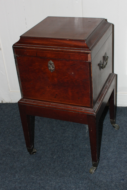 A George III mahogany decanter box, square form with raised top, on square tapered legs with carry