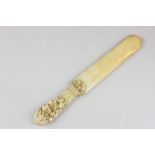 A 19th century ivory letter opener the handle carved as flowers and fruit, 26cm