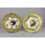 A pair of Royal Worcester porcelain cabinet plates, with hand painted central design of fruit,