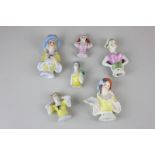 Six 20th century porcelain half dolls, one with a fan, another in a hat and one with a parrot on her