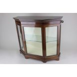 A mahogany table top display cabinet with single glazed door opening onto a glass shelf, on