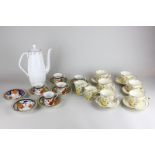 A set of six Phoenix ware Bouquet pattern tea cups and saucers with two jugs, a set of five