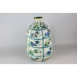 A Spanish pottery gourd shaped vase with floral motifs in bright colours, 29cm