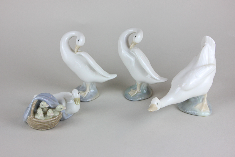 Two Lladro porcelain swans, a Lladro duck group and a Nao goose with box