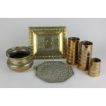 Two Persian brass trays and a basket, together with three brass ridged funnels