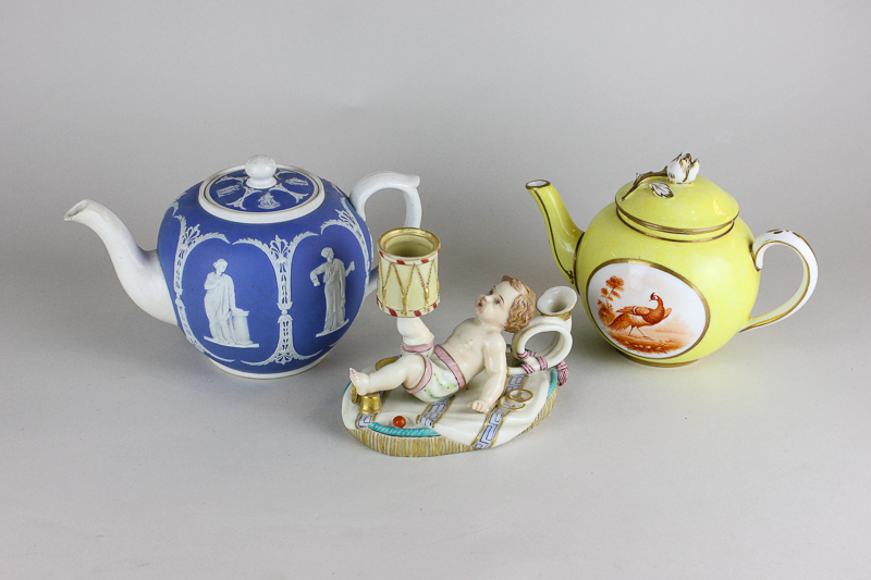 A Continental porcelain candlestick modelled as a small boy playing with instruments, a Jasper