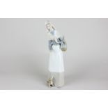 A Lladro porcelain figure, shepherd with dog and basket (ref 1034), 28cm high, with box