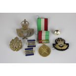 A Sultan of Oman's medal 1976, three RAF cap badges and two lapel badges