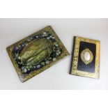 A Victorian black lacquered folder with gilt embellishment and large mother of pearl cabochon,