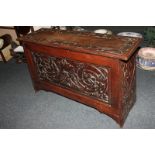 A narrow mahogany coffer with carved green man and floral decoration 91cm