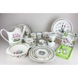 A collection of Portmerion Botanic Garden tableware including dinner plates, bowls, coffee cups,