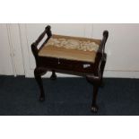 A mahogany piano stool, with upholstered rising seat, on cabriole legs with claw and ball feet,