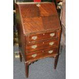 A 20th century mahogany bureau with banded edge, drop flap and three long drawers, on straight legs,