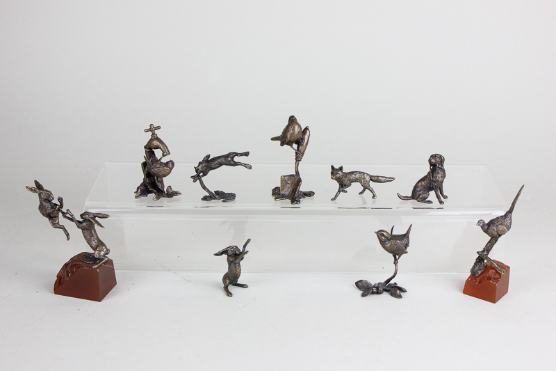 A collection of nine Butler and Peach small bronze sculptures of hares, birds, a fox and a dog,