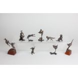 A collection of nine Butler and Peach small bronze sculptures of hares, birds, a fox and a dog,