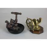 A bronzed metal squirrel nutcracker together with a brass nutcracker shaped as a ship's wheel