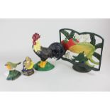 A painted metal cockerel doorstop, two painted metal door wedges modelled as a robin and a sun and