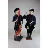 Two Spanish Falangist dolls of male and female youths in blue uniforms, 46cm, and three other