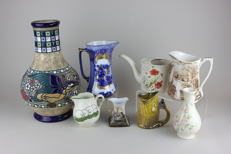 An Austrian pottery vase decorated with a kingfisher, a Royal Winton poppy watering can, five jugs