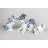 A Lladro porcelain figure of a dog, a Lladro cat figure and a Nao spaniel figure