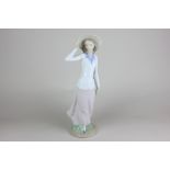 A Lladro porcelain figure Breezy Afternoon (ref 5682), 31cm high, with box