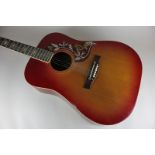 A Kent acoustic guitar with cherry colour body and hummingbird panel, 103cm