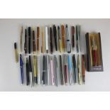 A collection of various fountain pens, ball point pens and mechanical pencils including Parker and