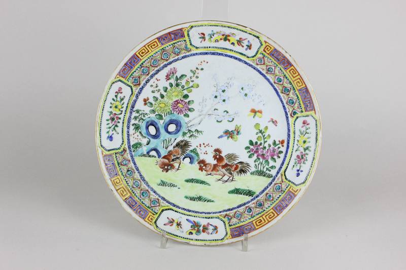 A Chinese porcelain plate with brightly coloured decoration of a cockerel in a garden, 24.5cm