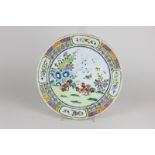 A Chinese porcelain plate with brightly coloured decoration of a cockerel in a garden, 24.5cm