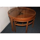 A 1960's circular glass topped coffee table with three nesting tables 81cm diameter