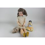 A Schoenau & Hoffmeister bisque head doll marked 1909, with sleeping eyes and open mouth with teeth,