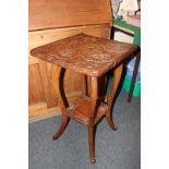 An Japanese carved wood occasional table square top deeply carved with flowers, on cabriole legs